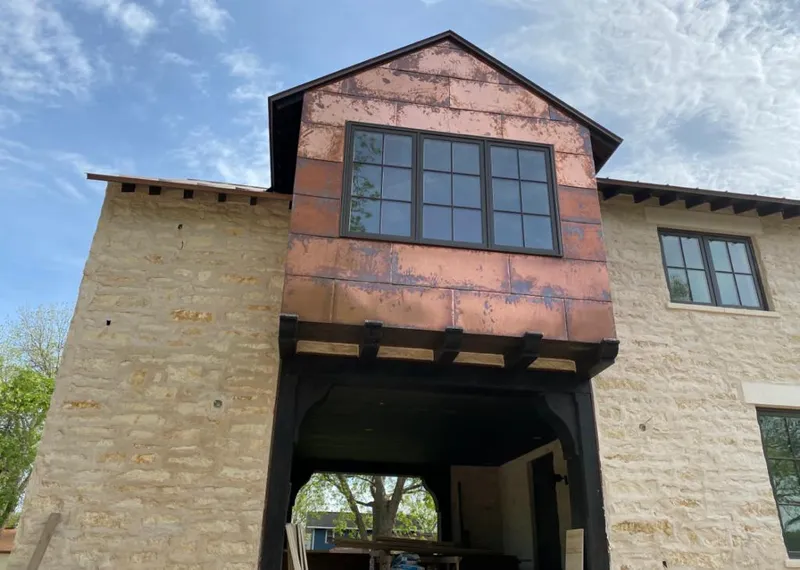 Copper metal panel facade on a stone building for Skylight Installation in Slidell